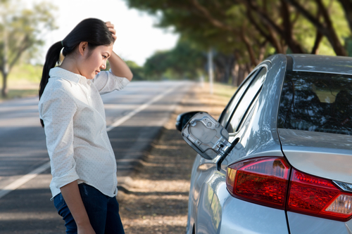Car oil down and Young woman confusing.